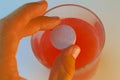 Person dropping electrolyte tablet into glass of water