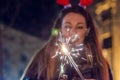 Photo of Sparkler with woman in background. Happy New Year. Royalty Free Stock Photo