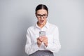 Photo of speechless business lady hold smartphone open mouth staring wear glasses white shirt isolated grey color