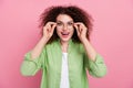 Photo of speechless smart woman with perming coiffure dressed shirt astonished staring touching glasses isolated on pink