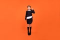 Photo of sporty champion schoolgirl jump achieve triumph wear uniform isolated orange color background