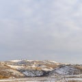 Photo Square Beautiful natural scenery with houses nestled on top of snow covered hills Royalty Free Stock Photo