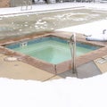 Photo Square Childrens pool and frozen adult swimming pool surrounded by snow in winter
