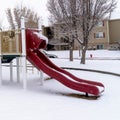 Photo Square Colorful playground for children at a park covered with snow at winter season Royalty Free Stock Photo