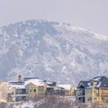 Photo Square frame Hilly residential terrain with charming homes and snowy natural beauty