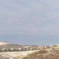 Photo Square frame Houses on neighborhood nestled on top of snowy hills viewed in winter Royalty Free Stock Photo