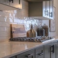 Photo Square frame Kitchen work area with cabinets cooktop countertop and tile backsplash Royalty Free Stock Photo