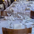 Photo Square frame Tableware arranged on round table with white cloth for eating at an occasion Royalty Free Stock Photo