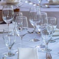 Photo Square frame Wine glasses spoons forks saucer plates and napkins on a table with white cloth Royalty Free Stock Photo