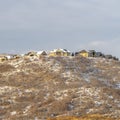 Photo Square Houses on neighborhood nestled on top of snowy hills viewed in winter Royalty Free Stock Photo
