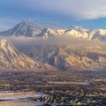 Photo Square Snowy Mount Timpanogos and charming homes against cloudy blue sky at sunset