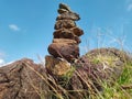 Photo of stack balanced stone at the peak of Maddo Hill, Barru, South Sulawesi, Indonesia. Low angle shot. Royalty Free Stock Photo