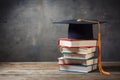 Photo Stack of books with mortarboard atop, symbolizing academic achievement and graduation success