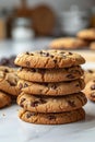 Photo of a stack of chocolate chip cookies on a white background with natural light and a blurred kitchen in the background Royalty Free Stock Photo