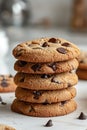 Photo of a stack of chocolate chip cookies on a white background with natural light and a blurred kitchen in the background Royalty Free Stock Photo