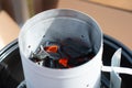 A photo of a starter bbq during the ignition of a flame for a gr