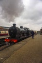 A photo of a steam train as it enters a platform