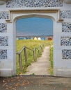 Stone arch gateway door entrance to beach seaside sea coast steps huts Royalty Free Stock Photo
