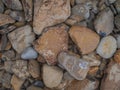 In the photo, stones of different sizes, which succumbed to atmospheric phenomena. Beige and gray tones. Close-up. Macro