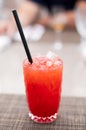 Strawberry lemonade pouring in glass from jug. Cocktail with strawberry, ice and mint in glasses on white concrete background, Royalty Free Stock Photo