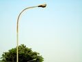 street lights during the day under a blue sky,