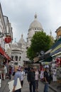 Street in Paris with souvenir stores and view to The Basilica of the Sacred Heart