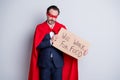 Photo of stressed beggar mature dismissed business guy super hero character costume hold carton placard need beg ask job