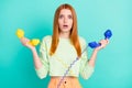 Photo of stressed millennial lady hold phones wear sport clothes isolated on vivid teal color background Royalty Free Stock Photo