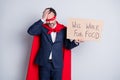 Photo of stressed troubled beggar mature dismissed business guy super hero character costume hold carton placard need