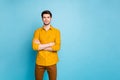 Photo of strict serious man with arms crossed looking at you intently near empty space isolated over blue pastel color Royalty Free Stock Photo