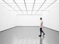 Photo of student in modern gallery looking at the empty canvas. Blank mockup, motion blur Royalty Free Stock Photo