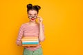 Photo of student nerd lady hold many books look tricky taking off funny freak glasses wear striped red white shirt green