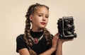 photo studio. cheerful girl with retro look isolated on white. kid vintage fashion. child take photo on retro camera Royalty Free Stock Photo