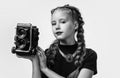 photo studio. cheerful girl with retro look isolated on white. kid vintage fashion. child take photo on retro camera Royalty Free Stock Photo