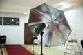 Photographic studio strobe lighting and reflective umbrella . Photo studio Silver Photo Studio Reflective Umbrella Royalty Free Stock Photo