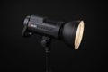 Photo studio strobe light flash bulb monoblock. Close up view of professional studio strobe flash lamp on black background. Jinbei Royalty Free Stock Photo