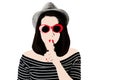 Photo in the style of pop art. Woman in red sunglasses shows gesture Shhh.