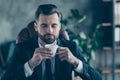 Photo of successful business guy hold coffee beverage mug thoughtful eyes closed enjoy pleasant smell wear black blazer