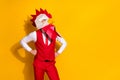 Photo of successful cocky guy hands hips look camera wear rooster mask red suit isolated yellow color background Royalty Free Stock Photo