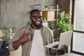 Photo of successful guy designer developer hold laptop make thumb up symbol suggest service support testing software in Royalty Free Stock Photo