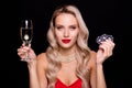 Photo of successful smiling lady wear sexy outfit playing casino drinking wine isolated black color background