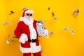 Photo of successful wearing red santa claus funny costume hold glass jar full money spending deposit isolated on yellow Royalty Free Stock Photo