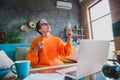 Photo of suffering heat elderly lady wear orange pullover turning on broken air conditioning indoors apartment room Royalty Free Stock Photo