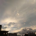 a photo of the sunset sky and the silhouette of a simple building