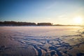 Photo of a sunset at winter snowy field, peaceful stunning landscape, amazing seasonal nature, cold weather in the park Royalty Free Stock Photo