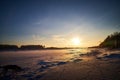 Photo of a sunset at winter snowy field, peaceful stunning landscape, amazing seasonal nature, cold weather in the park Royalty Free Stock Photo