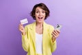 Photo of surprised funny girl brown hair wear lime yellow suit holding plastic mastercard phone account isolated on