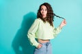 Photo of surprised young woman hold curl look empty space wear casual isolated on turquoise color background