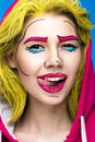 Photo of surprised young woman with professional comic pop art make-up. Creative beauty style.