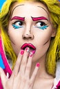 Photo of surprised young woman with professional comic pop art make-up and design manicure. Creative beauty style.